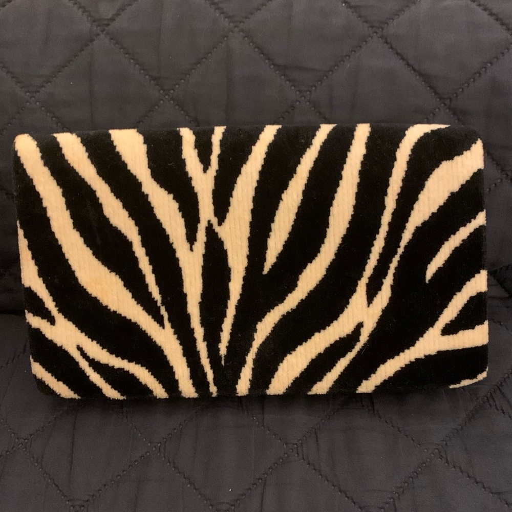 Adorable Arm Candy black and white zebra fold-over flap clutch.